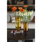 Modern, understated glass vase, cylindrical shape on a solid base, warm dark orange, OMAHA14AM